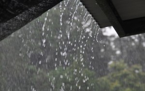 Rain cascades off the roof