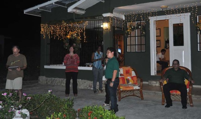 Outdoors, watching all the fireworks in the neighborhood.