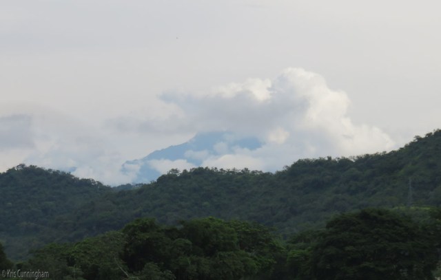 Volcan Baru peeks out from behind the hills and the clouds. 