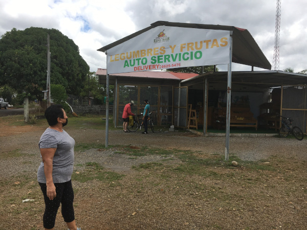 The drive up area of the market. The employee is helping Joel load our purchases on to my bike.